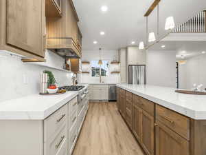Kitchen with brown cabinets, open shelves, pendant lighting, light stone countertops, and recessed lighting