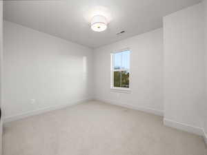 Unfurnished room featuring light colored carpet and baseboards