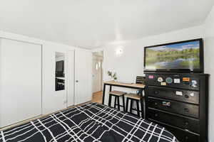 Bedroom with a closet and wood finished floors