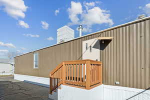 View of side of home with a central air condition unit