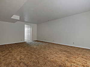 Unfurnished room featuring baseboards and carpet