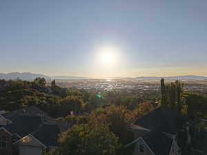 Aerial view of property and surrounding area with a mountain backdrop