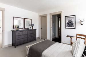 Bedroom with carpet flooring and ensuite bath