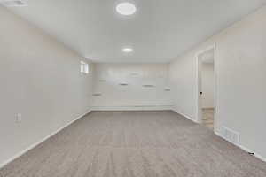 Unfurnished room featuring light carpet and recessed lighting