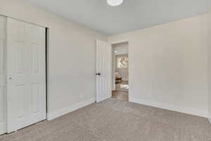 Unfurnished bedroom with carpet and a closet