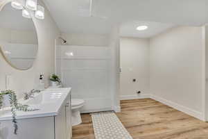 Bathroom featuring vanity, light wood-style floors, and tub / shower combination