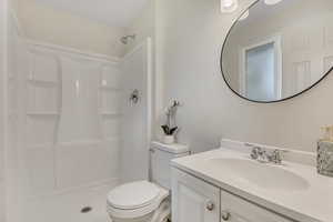 Bathroom featuring vanity and a walk in shower