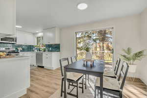 Dining area featuring light wood finished floors and recessed lighting