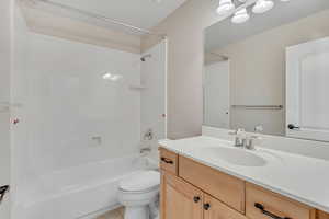 Bathroom featuring  shower combination, vanity, and light tile patterned flooring