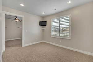 Unfurnished room with light carpet, recessed lighting, and a ceiling fan