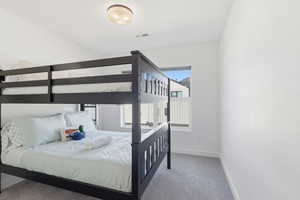 Bedroom with carpet floors and baseboards