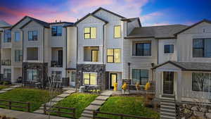 Modern farmhouse style home featuring a residential view, board and batten siding, and a lawn
