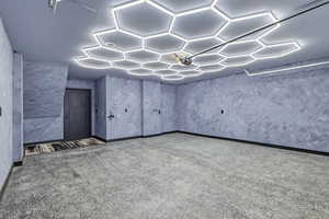 Below grade area featuring baseboards and carpet floors