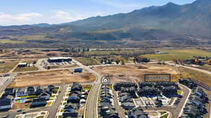 Aerial view of property's location with nearby suburban area and mountains