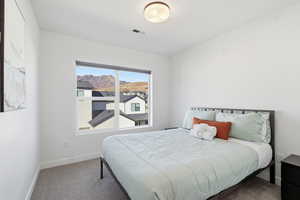 Carpeted bedroom with baseboards