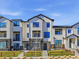 View of front of home featuring board and batten siding and stone siding