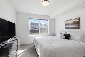 Bedroom featuring light carpet and baseboards