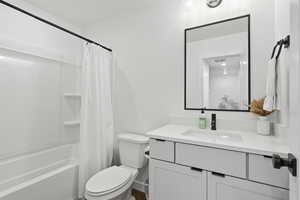 Bathroom featuring vanity and shower / tub combo with curtain