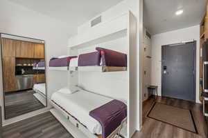Bedroom with dark wood-style flooring