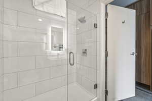 Full bath featuring a shower stall