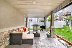 View of patio featuring outdoor lounge area and a grill