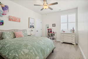Bedroom featuring light colored carpet and ceiling fan