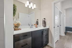 Bathroom featuring vanity and light wood-style floors