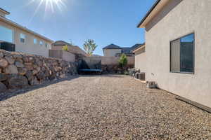 Fenced backyard with a trampoline