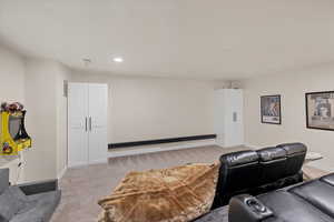 Cinema featuring light carpet and recessed lighting