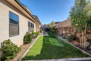 Fenced backyard featuring a trampoline and a patio