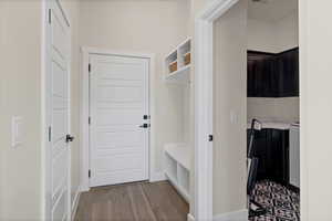 Mudroom with wood finished floors and baseboards