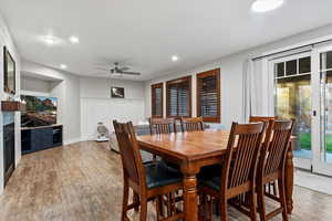 Dining room with a ceiling fan, recessed lighting, and light wood-style floors