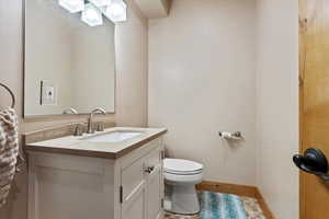 Half bath featuring vanity and light wood-style floors