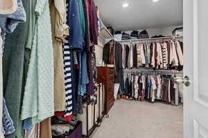 Spacious closet featuring light carpet and radiator
