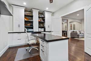 Office featuring a ceiling fan, recessed lighting, dark wood finished floors, built in study area, and crown molding