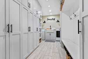 Mudroom featuring recessed lighting and separate washer and dryer