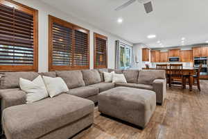 Living area featuring light wood-type flooring, recessed lighting, and ceiling fan