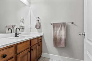 Bathroom featuring vanity and baseboards