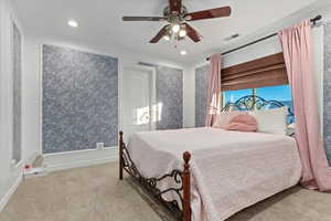Bedroom with light colored carpet, a ceiling fan, and recessed lighting