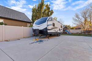 View of parking featuring a fenced backyard, a playground, and a trampoline