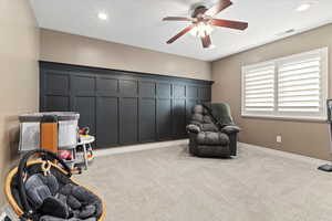 Living area featuring carpet flooring, ceiling fan, and recessed lighting