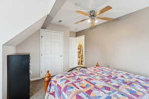Carpeted bedroom featuring a ceiling fan and baseboards