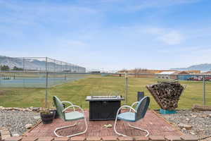 View of patio with a mountain view and a fire pit