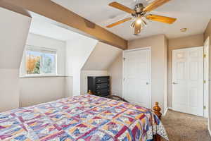 Bedroom featuring carpet floors, a ceiling fan, and vaulted ceiling