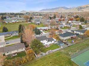 Aerial view of property's location with nearby suburban area and mountains