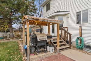 View of patio / terrace with a grill and a gazebo