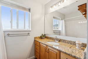 Bathroom featuring vanity and curtained shower
