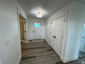 Foyer featuring dark wood-type flooring and a textured ceiling