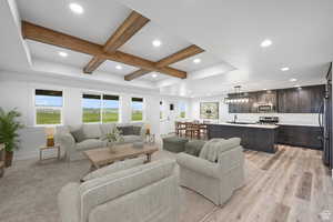 AI: Living area with beamed ceiling, recessed lighting, and light wood-style flooring