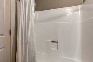 Bathroom featuring curtained shower